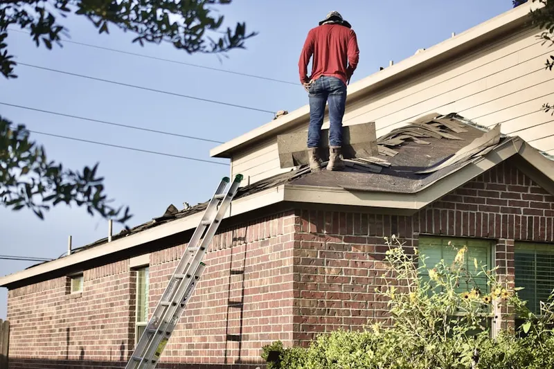 Professional roofer working on a residential roof in Miami Avenue